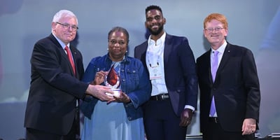 Mark Batenic, Gwen Christon, Simon Christon, John Ross pose for a photo as Gwen receives Spirit of IGA Award